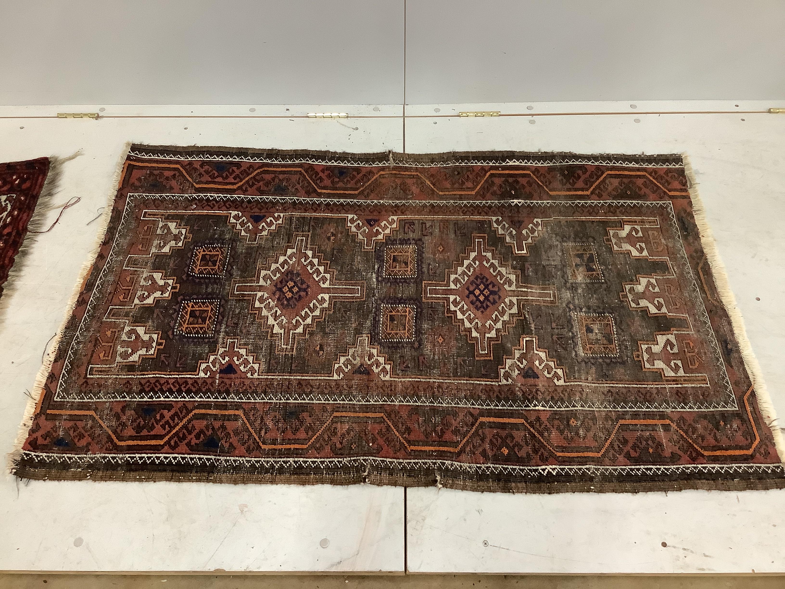 A Caucasian blue ground rug, worn together with an Afghan style rug, larger 140 x 85cm